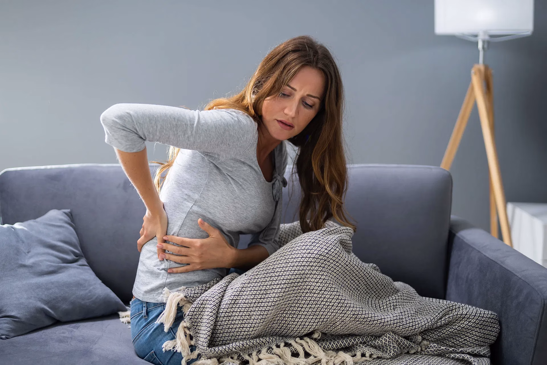 woman holding back in pain